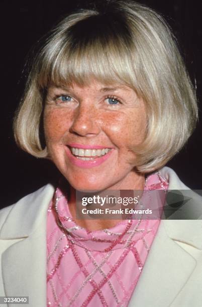 Headshot of American actor Doris Day wearing a pink blouse at a Doris Day look-alike contest.