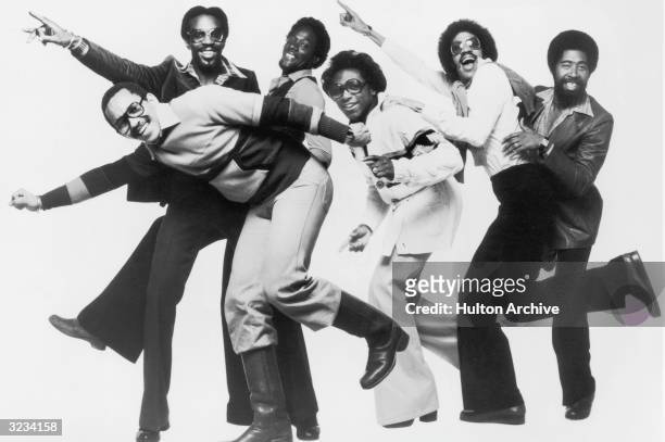 Full-length studio portrait of the American R&B and funk group the Commodores striking a pose of moving in a forward direction. Lead singer Lionel...
