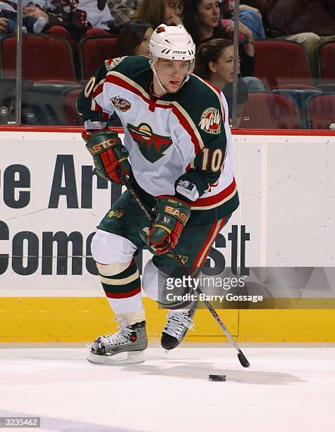 Right wing Marian Gaborik of the Minnesota Wild advances the puck during the game against the Phoenix Coyotes at Glendale Arena on March 7, 2004 in...