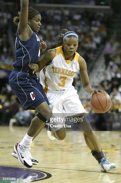 Tasha Butts of the Tennessee Lady Vols dribbles against the defense of Barbara Turner of the University of Connecticut Huskies during the National...