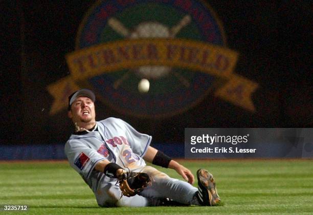 Right fielder Karim Garcia of the New York Mets slides attempting to catch a fly ball from Marcus Giles of the Atlanta Braves in the 8th inning on...