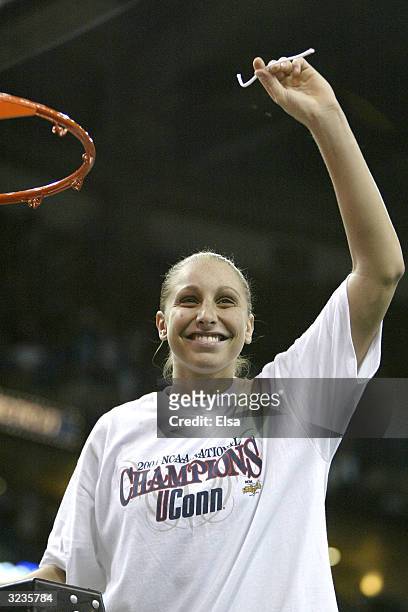 Diana Taurasi of the University of Connecticut Huskies cuts down the net and waves to the crowd after defeating the Tennessee Lady Vols 70-61 in the...