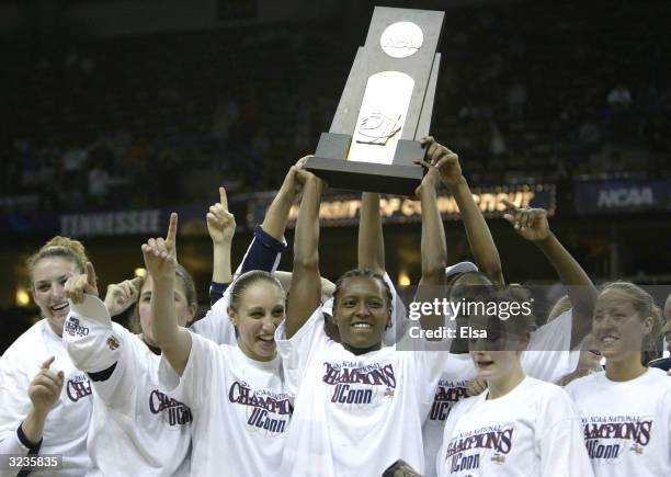 Ashley Battle , Diana Taurasi , and Maria Conlon of the University of Connecticut Huskies hold the NCAA National Championship trophy after defeating...