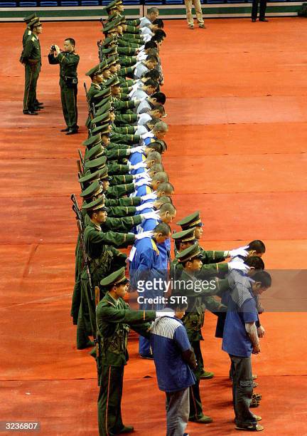 Chinese police show of a group of hardcore convicts at a sentencing rally in the east Chinese city of Wenzhou, 07 April 2004, where 11 prisoners were...