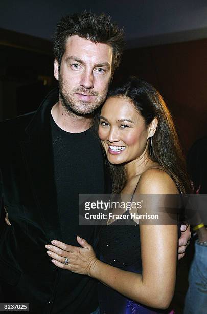 Actress Tia Carrere and husband Simon Wakelin pose at the Playstation 2 party with the Vines, Jet and the Living End at Avalon club on April 6, 2004...