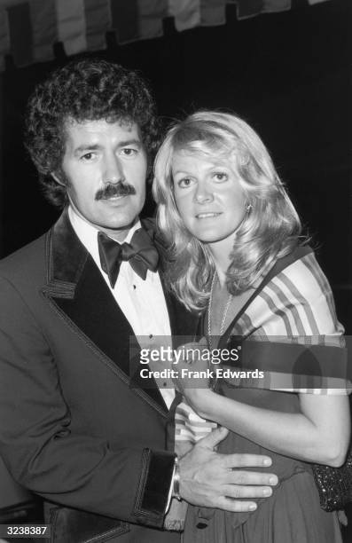 Canadian game show host Alex Trebek stands with his wife, Elaine, at the Annual Thalian Ball, California. He is wearing a velvet-trimmed tuxedo, and...