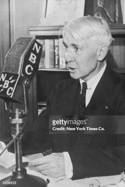 American poet and author Carl Sandburg reads during an NBC radio broadcast.