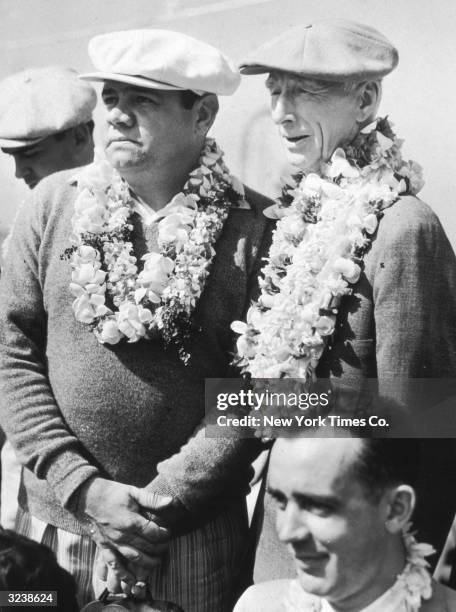 American baseball player Babe Ruth and baseball manager Connie Mack of the Philadelphia Athletics wear leis, which they received upon their arrival...