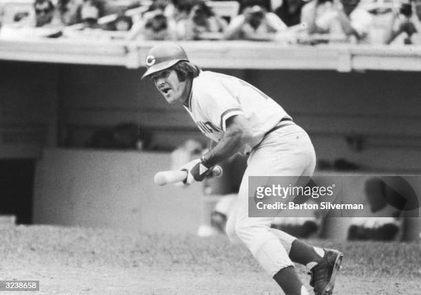 American baseball player Pete Rose of the Cincinnati Reds, bunts in a game against the Mets during his 44 game hitting streak at Shea Stadium,...