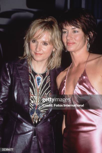 American rock singer and songwriter Melissa Etheridge and her girlfriend, Julie Cypher, attending the American Music Awards, Shrine Auditorium, Los...