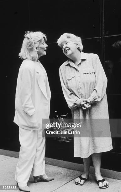 Full-length image of American actor Maureen Stapleton talking with Carol Matthau, wife of actor Walter Matthau, on the sidewalk after a lunch at the...