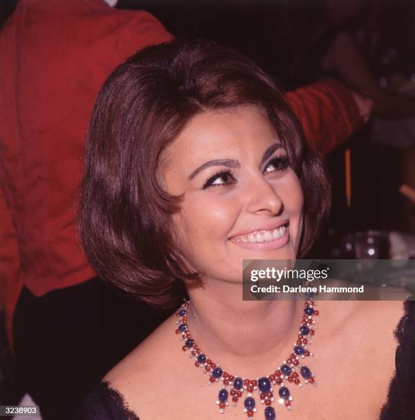 Headshot of Italian actor Sophia Loren wearing a jeweled necklace at a party honoring her Academy Award and her appearance in director Federico...
