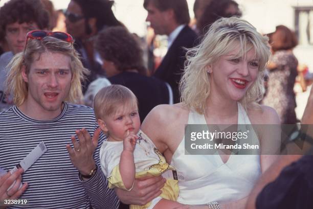 Kurt Cobain , lead singer of the American rock group Nirvana, his wife, Courtney Love, lead singer of the American rock group Hole, and their...