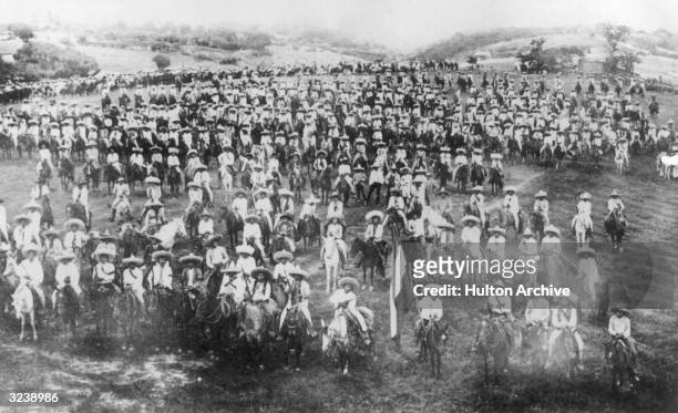 Mexican revolutionaries Pancho Villa and Emiliano Zapata assemble with their army of peasants and farmers on horseback, Mexico.