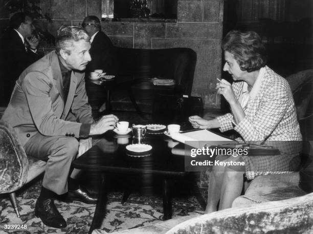 Movie and celebrity fashion designer Oleg Cassini being interviewed in Milan shortly after signing a contract to produce exclusive sportswear and...