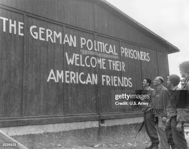 Soldiers of the 46th Armored Infantry, 5th Armored Division, US Ninth Army, and their guide read, 'THE GERMAN POLITICAL PRISONERS WELCOME THEIR...