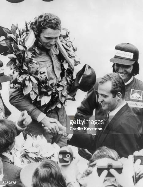 Austrian Formula 1 racing driver Niki Lauda is congratulated by Prince Juan Carlos after winning the Spanish Grand Prix at the Jarama Circuit,...