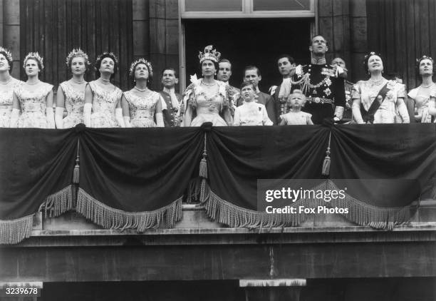 Queen Elizabeth II and her family and attendants face the crowds from the balcony of Buckingham Palace on the day of her coronation.