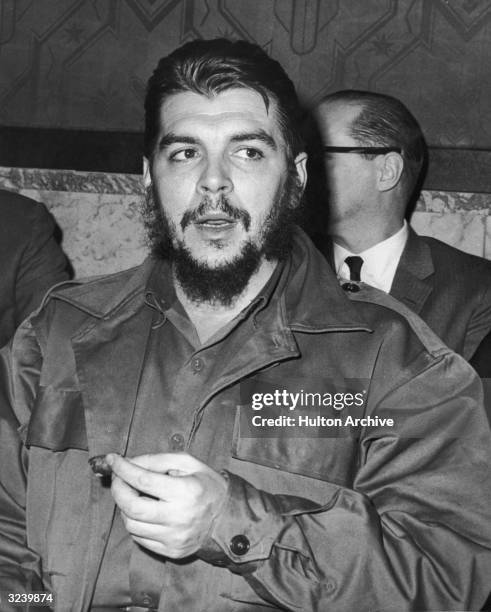 Argentinian-born revolutionary leader Ernesto 'Che' Guevara , Minister of Industry for Cuba, smokes a cigar after his speech at the UN General...