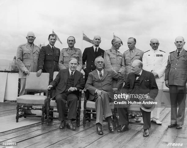 Canadian prime minister Mackenzie King , American president Franklin Delano Roosevelt , and British prime minister Winston Churchill sit while...