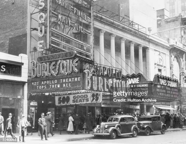People wait in line beneath the marquees of the 42nd Street Apollo Theatre and the Times Square Theater, Midtown Manhattan, New York City.