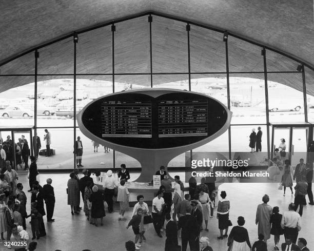 View of an arrival and departure notification board near the entrance of the TWA terminal at Kennedy Airport, New York, designed by Eero Saarinen.