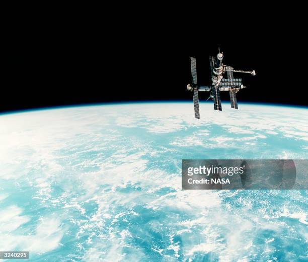Russia's Space Station Mir flying over the Pacific Ocean during a rendezvous operation with the Space Shuttle Discovery.