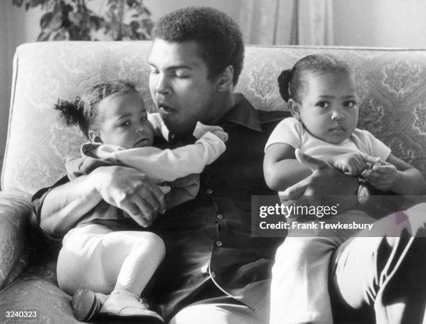 Heavyweight boxer Muhammad Ali with his daughters Laila and Hanna at Grosvenor House.