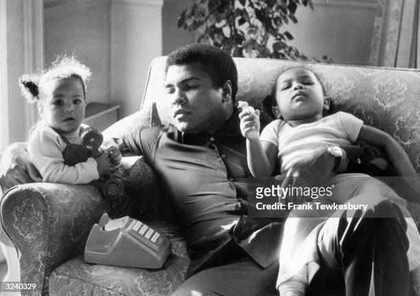 Heavyweight boxer Muhammad Ali with his daughters Laila and Hanna at Grosvenor House.