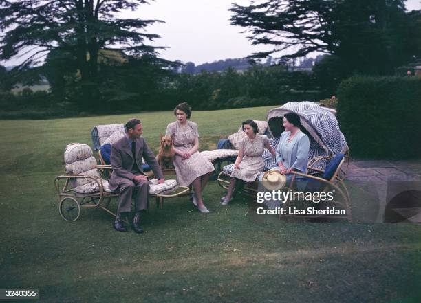 King George VI with his wife Queen Elizabeth and their daughters Princess Elizabeth and Princess Margaret at Royal Lodge in Windsor.