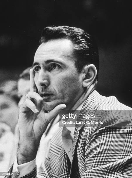 American basketball coach Bob Cousy of Boston watches the action on court at a New York University versus Boston College basketball game at Madison...