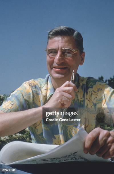 American author and illustrator Dr Seuss sits with pen and paper as he works on his book 'How the Grinch Stole Christmas' by his pool in La Jolla,...