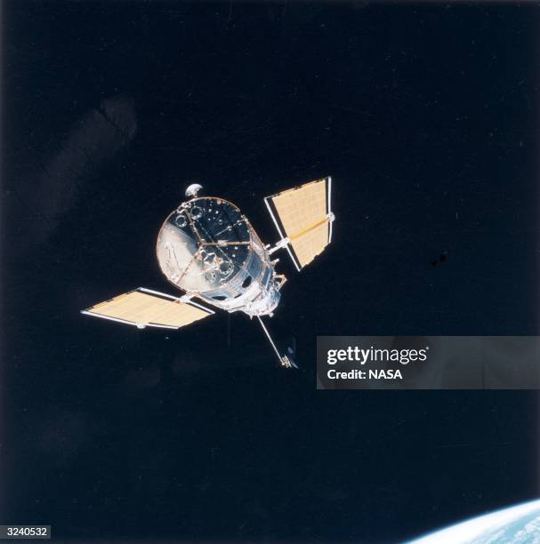 The Hubble Space Telescope just after leaving the cargo bay of the Space Shuttle Endeavour where it docked for repairs. Part of Earth's horizon can...