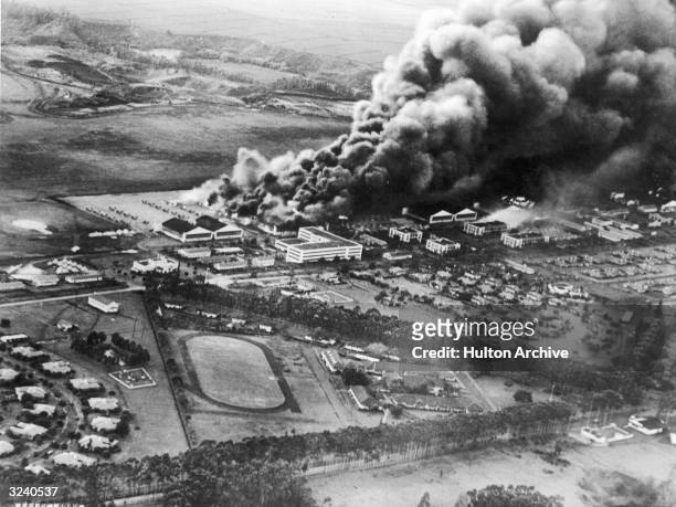 Aerial view of the US Hawaiian Air Base at Wheeler Airfield burning after the Japanese attack on Pearl Harbor, Honolulu, Hawaii. Photograph taken by...