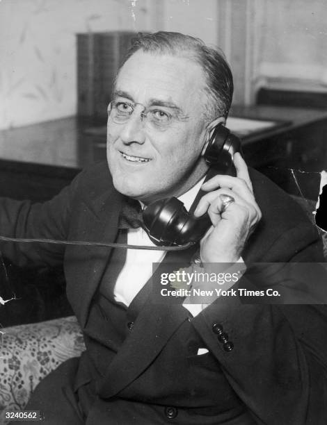 Portrait of New York Governor Franklin Delano Roosevelt speaking on a telephone. Roosevelt served as the 32nd United States President from 1932-45.