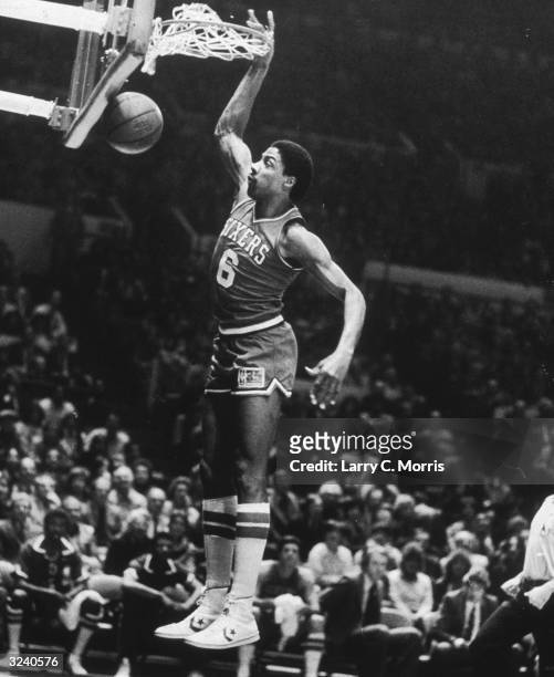 American basketball player Julius Erving, aka 'Dr J,' of the Philadelphia 76ers going up for 2 of his 30 points in a game against the New York...