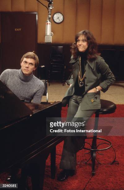 American musicians Richard and Karen Carpenter , the brother and sister pop duo The Carpenters, in a recording studio.