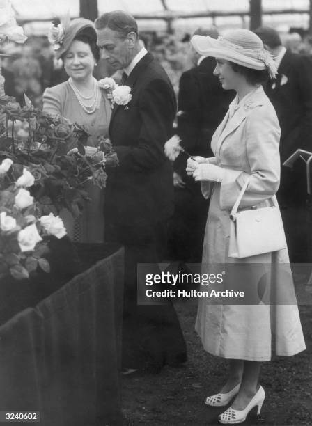 The Queen and King George VI admiring Harry Mallory type roses at the Chelsea Flower Show in the grounds of the Royal Hospital. Princess Margaret...