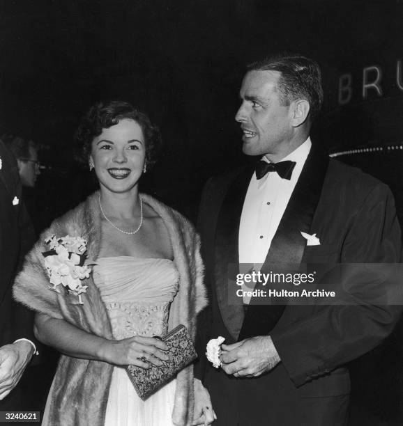 American actor Shirley Temple and her husband, Charles Black, pose together at the premiere of director William Wyler's film, 'Roman Holiday'. Temple...