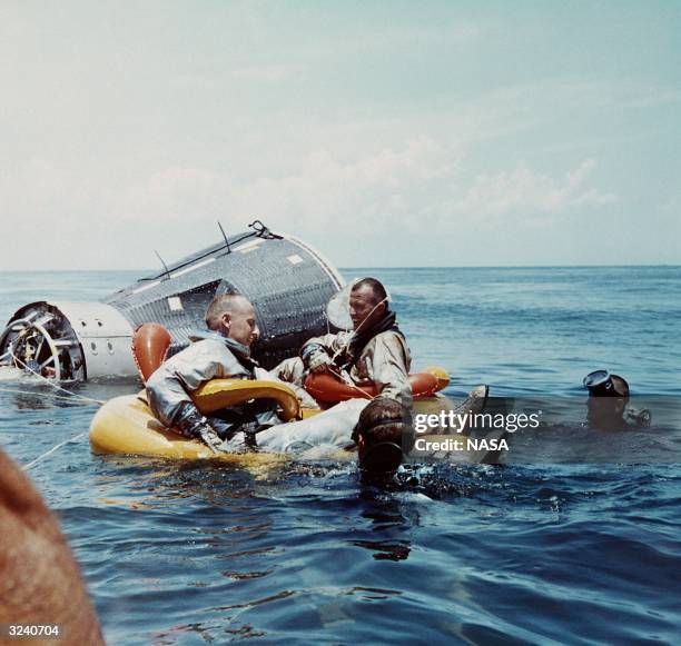 Navy divers recover Commander C Gordon Cooper and pilot Charles 'Pete' Conrad Jr after the splashdown of the Gemini V capsule in the Atlantic Ocean.