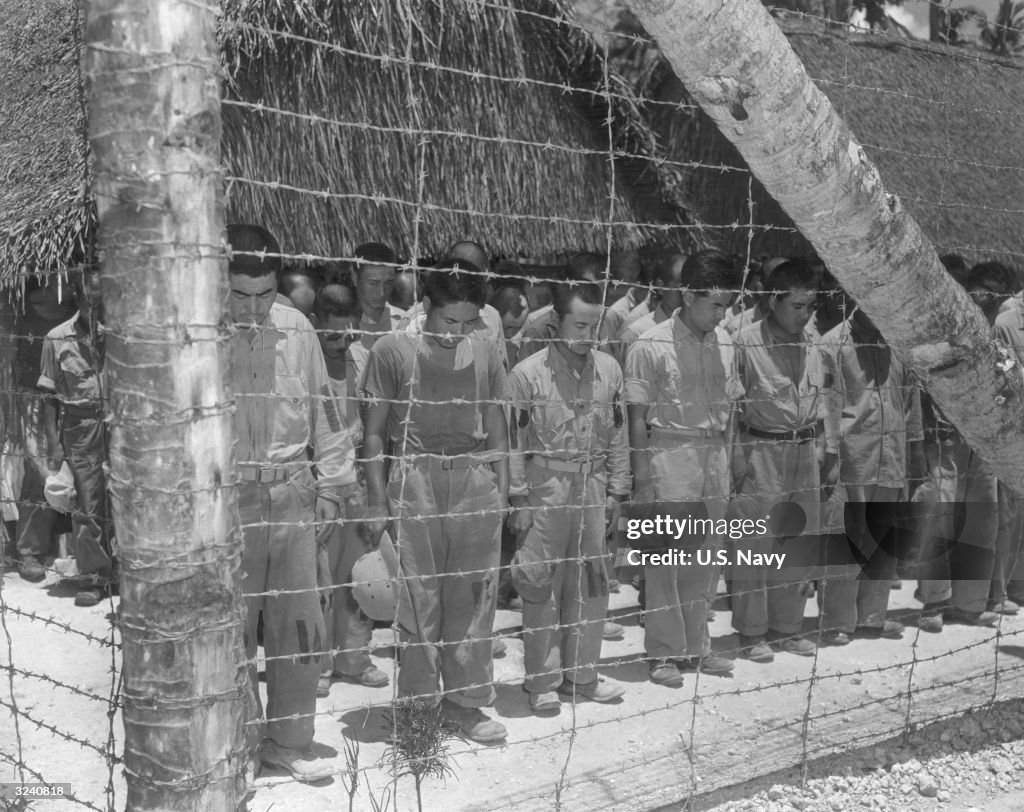 Japanese Pow Rations Full-length image of Japanese POWs standing in rows with their heads ...