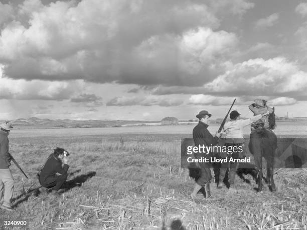 From left to right, Taylor Williams, Hungarian-born photojournalist Robert Capa , Neil Regan, American writer Ernest Hemingway and John Meyers during...