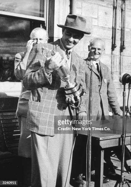American golfer Sam Snead holding the British Open Golf Championship trophy after he won, St. Andrews, Scotland.