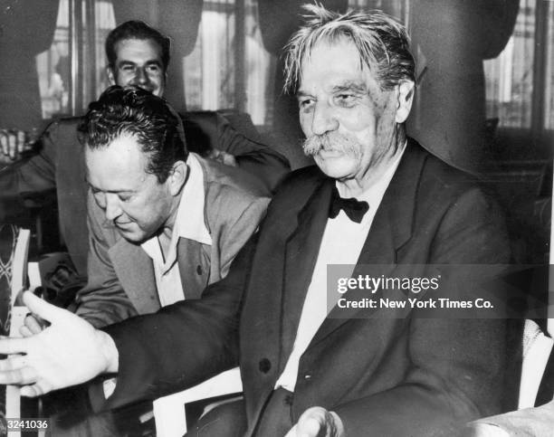 French medical missionary and humanitarian Albert Schweitzer talks to reporters during a press conference aboard the New Amsterdam prior to leaving...