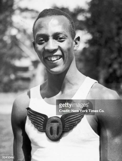 American track athlete Jesse Owens smiles just after he broke the world record for the 100 meter dash as a high school student, Cleveland, Ohio.