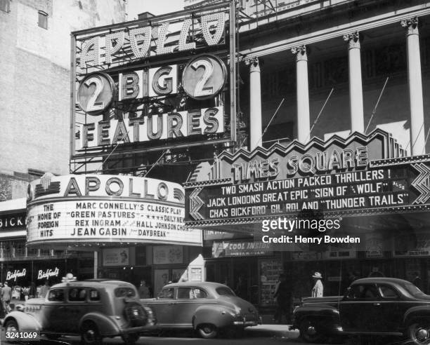 The marquees of the Apollo and Times Square theaters in the midtown neighborhood of New York City.