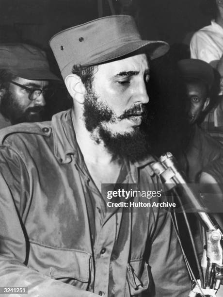 Cuban communist leader Fidel Castro, wearing military fatigues, sits in front of a microphone while speaking to the people of Camaguey, Cuba.