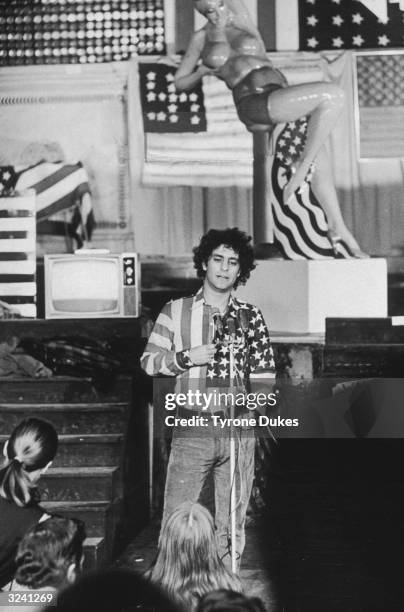 American activist Abbie Hoffman , cofounder of the Yippie movement, speaks to a crowd while wearing a shirt made from a US flag during an American...