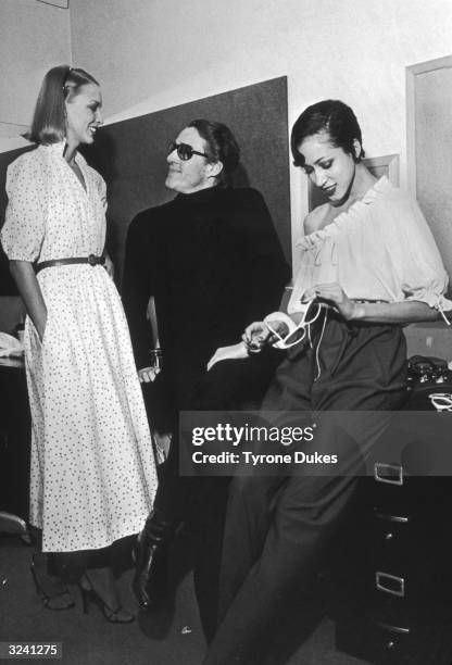 American fashion designer Halston talks with models before a summer collection show in New York City.