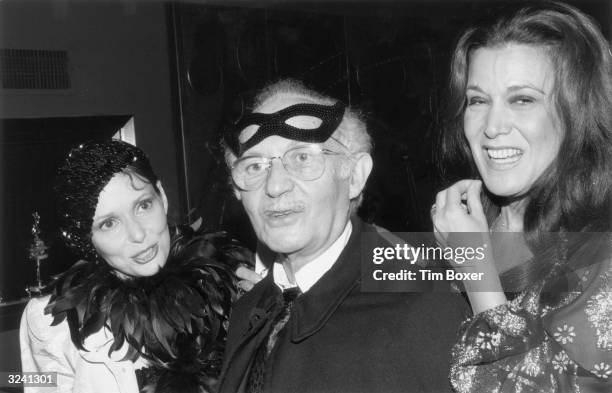 Ukrainian-born actor, teacher, and director Lee Strasberg flanked by his daughter, actor Susan, , and his wife, Anna, at a masquerade benefit for the...